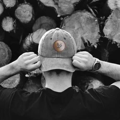 Black and white picture of the back view of a man wearing a BryBerry hat.